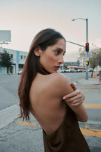 Black satin backless camisole by SAINT CLAIRE, featuring a sleek, smooth fabric and elegant backless design.