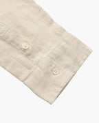 Saint Moritz Bora Bora Resort shirt made of 100% linen, lightweight and stylish, shown on a hanger with a beach background