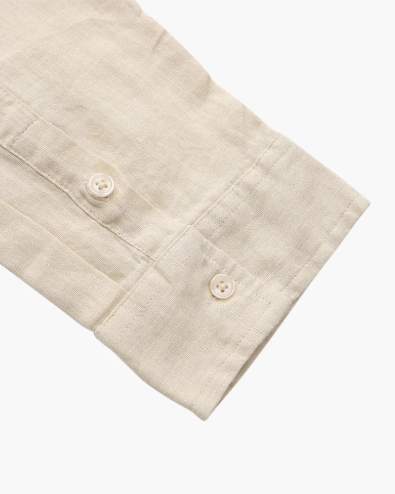 Saint Moritz Bora Bora Resort shirt made of 100% linen, lightweight and stylish, shown on a hanger with a beach background