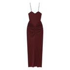 Saint Claire Riviera satin dress displayed on a hanger, showcasing smooth fabric and elegant design in a stylish wardrobe setting.
