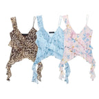 SAINT CLAIRE Marbella Statement Top displayed on a hanger, featuring vibrant fabric and stylish design for a bold fashion statement.