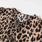 SAINT CLAIRE Aurélie Ruffle Blouse with feminine ruffle details and lightweight fabric, shown on a hanger.