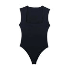 Saint Claire Épure Slim Bodysuit in black, close-up of sleek, fitted design with smooth fabric and high neckline.