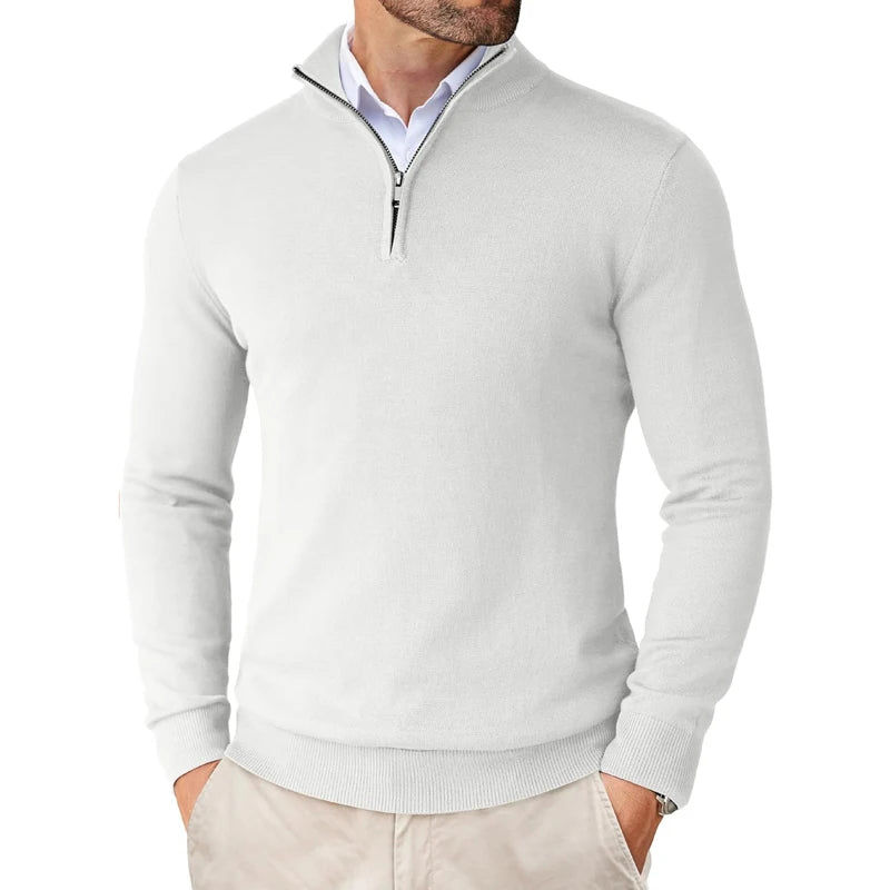 Saint Moritz Essential Winter Pullover, cozy knit sweater in neutral tones, displayed on a wooden background.