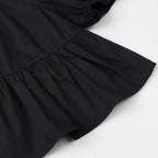 SAINT CLAIRE Aurélie Ruffle Blouse featuring delicate ruffles and lightweight fabric, perfect for a stylish, feminine look.