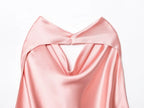 SAINT CLAIRE Noir satin backless camisole hanging on a hanger, showcasing smooth satin fabric and elegant backless design.